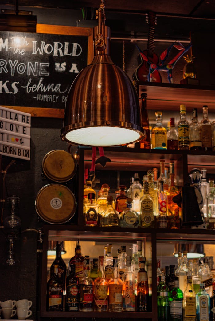 A well-stocked bar with warm lighting and decor in Barcelona, creating a cozy atmosphere.